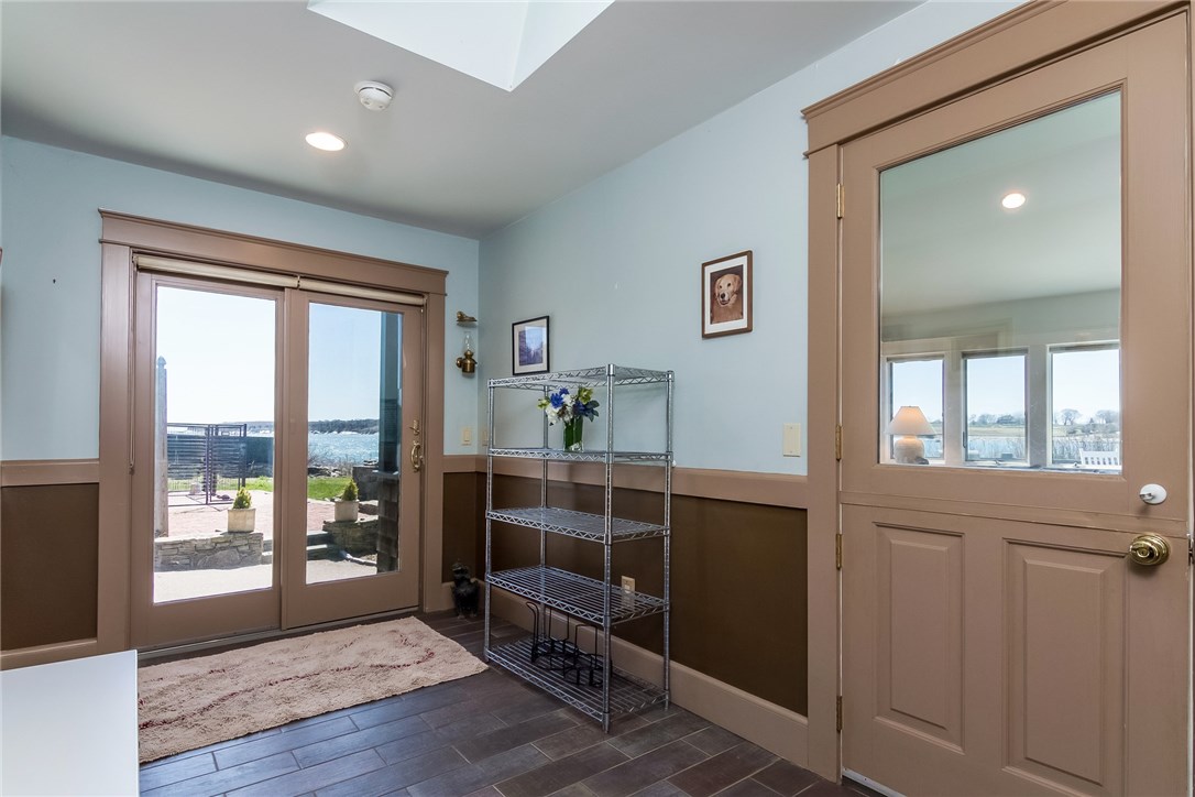 7 Beavertail Road Jamestown, RI 02835 - Photo 23 of 37 A large mudroom offers many possibilities and has a Dutch-door to the family room and sliders to both the back entrance and the waterside of the home