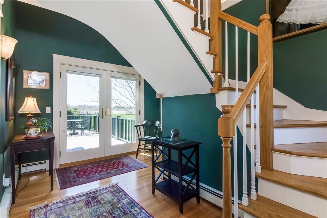 7 Beavertail Road Jamestown, RI 02835 - Photo 10 of 37 A sweet foyer with water views, access to the waterside porch and a sweeping staircase to the second floor master suite welcomes you to the home