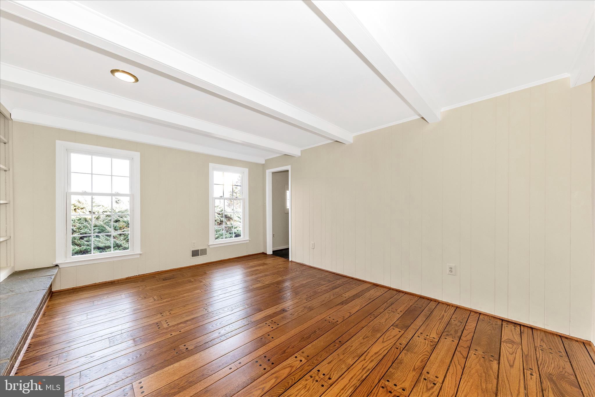 5815 Meadow Road Frederick, MD 21702 - Photo 19 of 55 a view of an empty room with wooden floor and a window