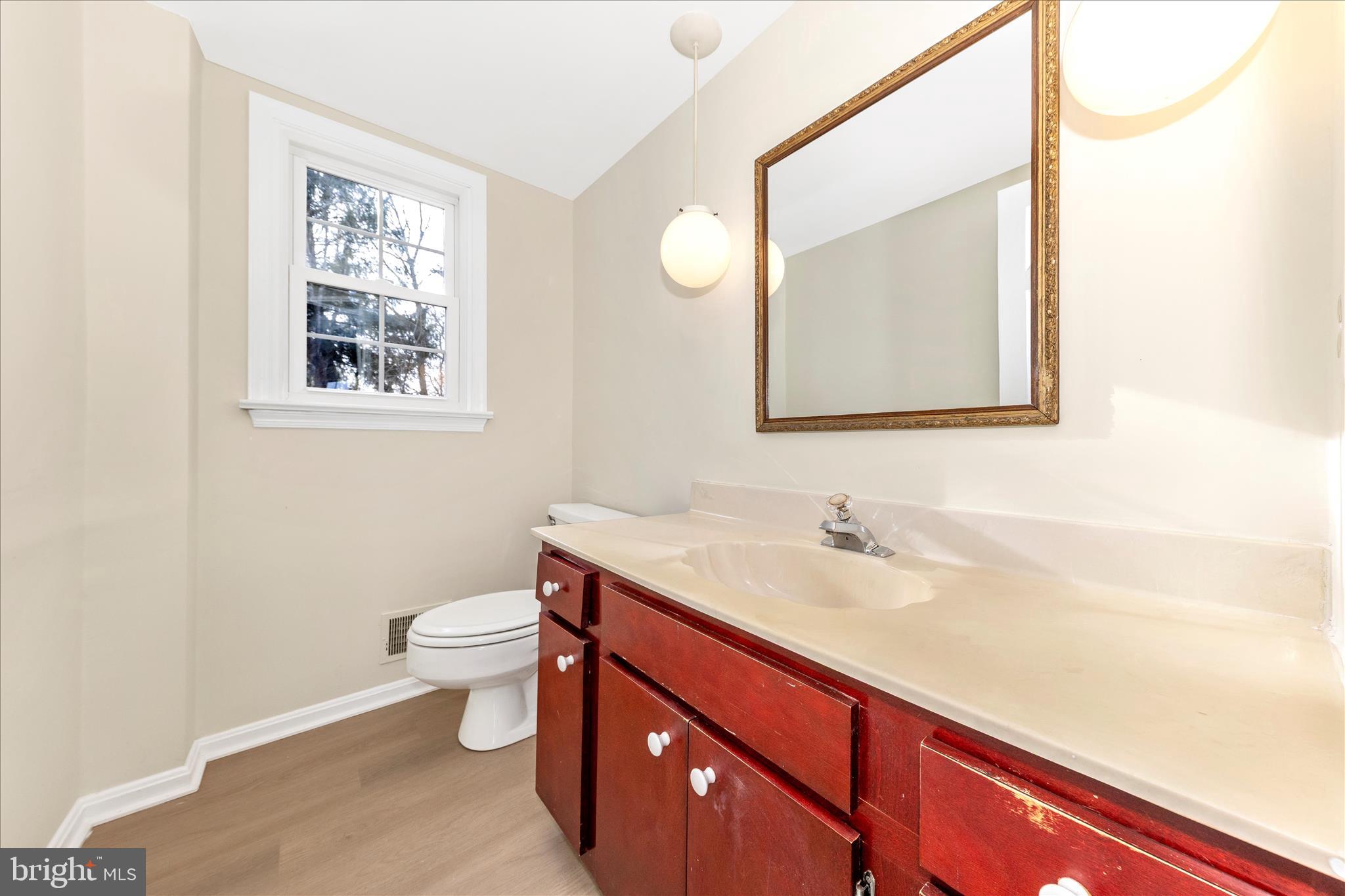 5815 Meadow Road Frederick, MD 21702 - Photo 21 of 55 a bathroom with a toilet sink and mirror