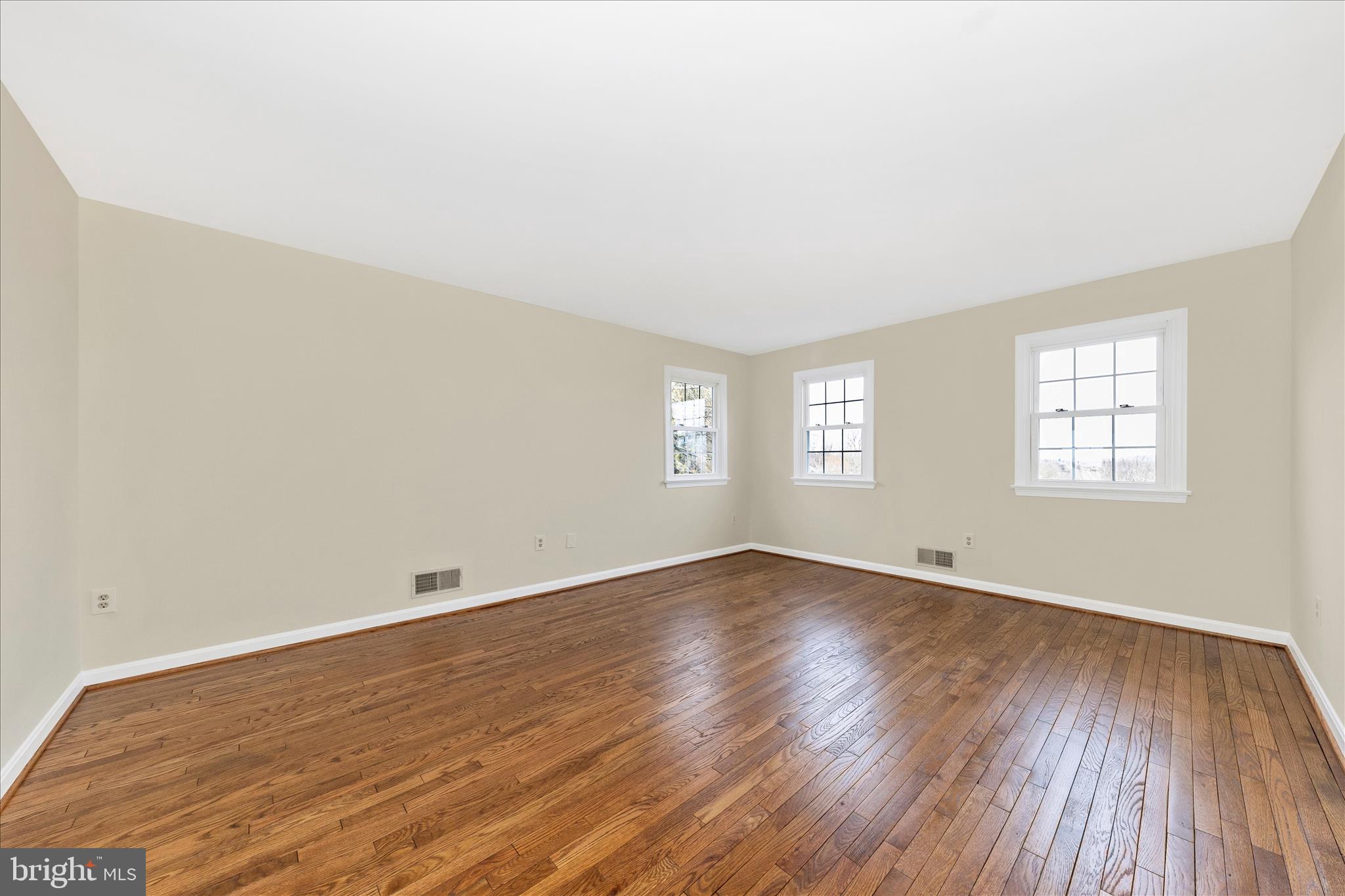 5815 Meadow Road Frederick, MD 21702 - Photo 24 of 55 an empty room with wooden floor and windows