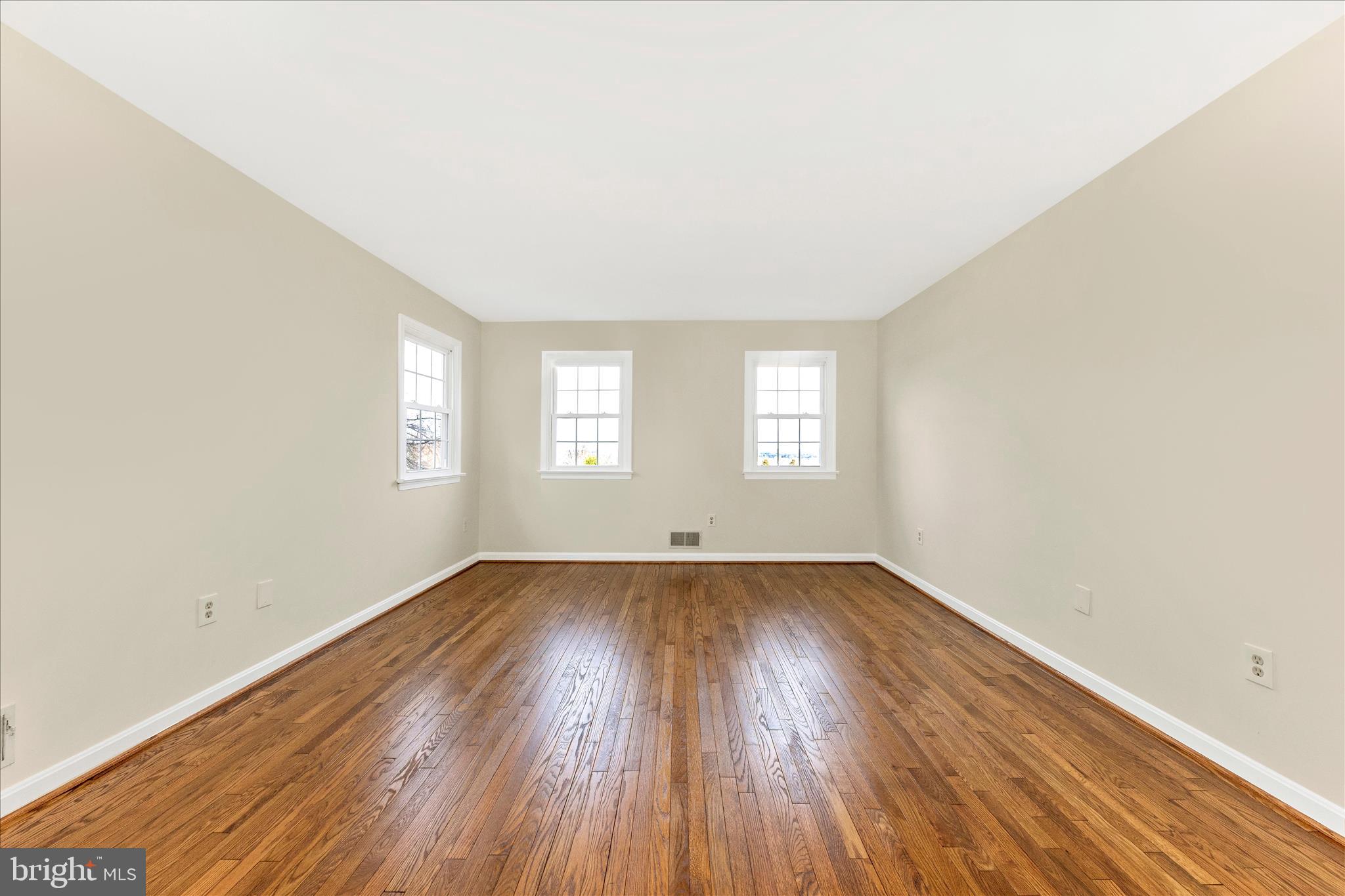 5815 Meadow Road Frederick, MD 21702 - Photo 25 of 55 an empty room with wooden floor and windows