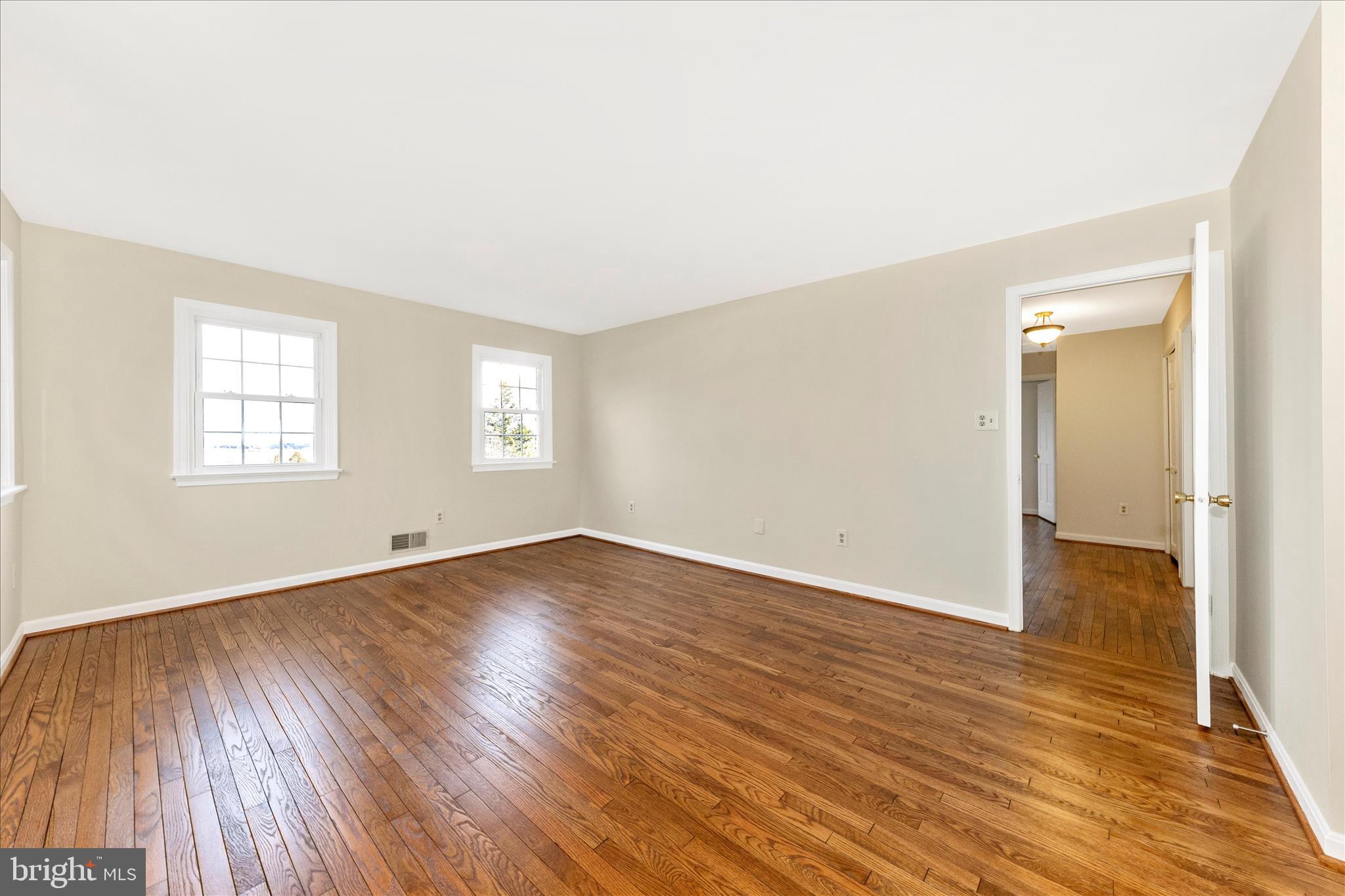 5815 Meadow Road Frederick, MD 21702 - Photo 26 of 55 an empty room with wooden floor and windows