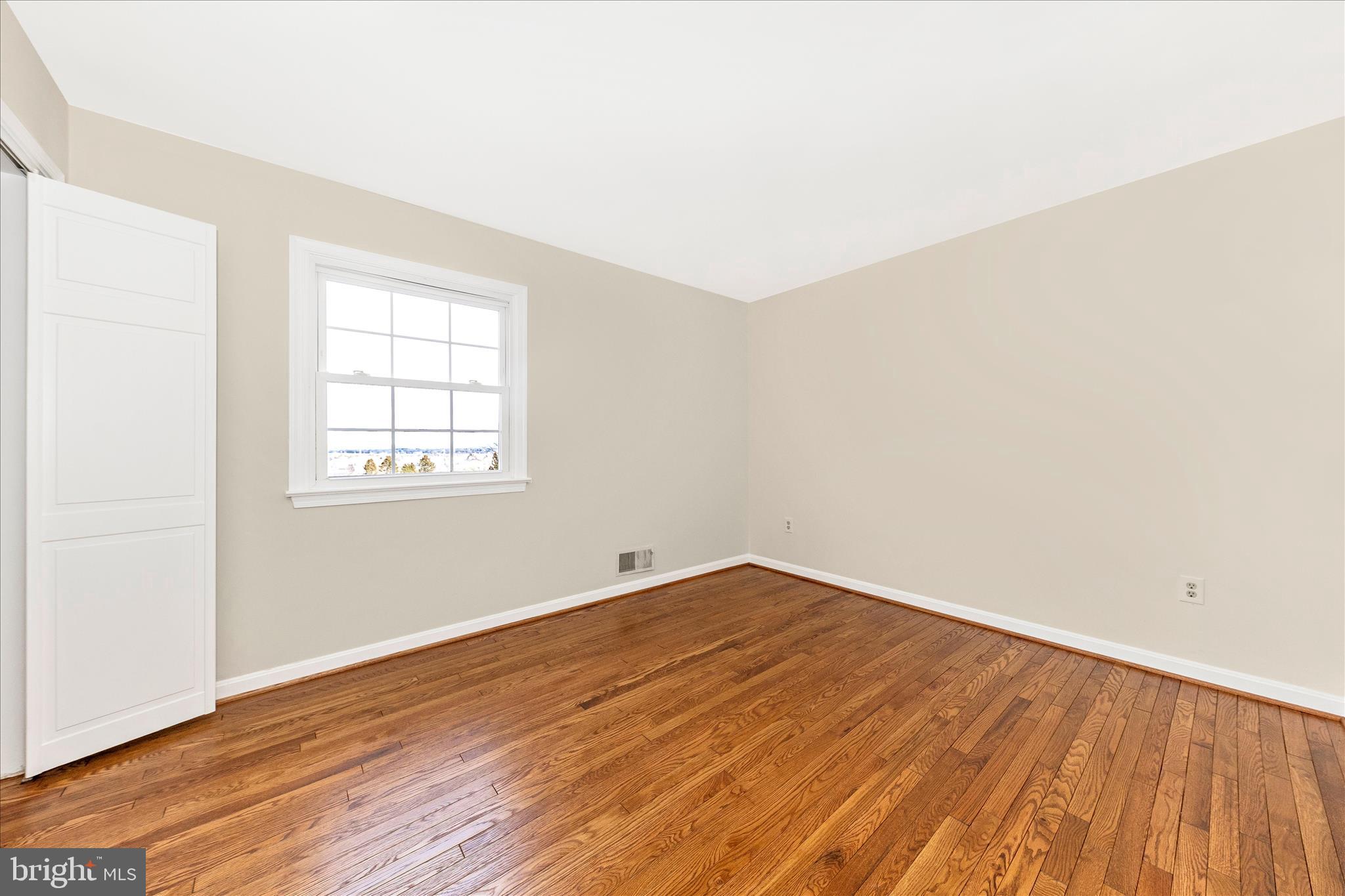 5815 Meadow Road Frederick, MD 21702 - Photo 30 of 55 an empty room with wooden floor and windows