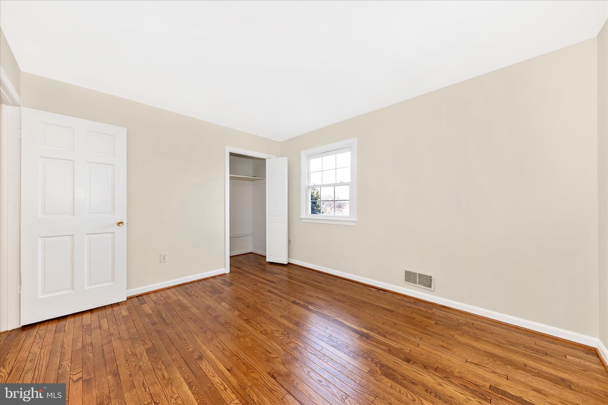 5815 Meadow Road Frederick, MD 21702 - Photo 31 of 55 an empty room with wooden floor and windows