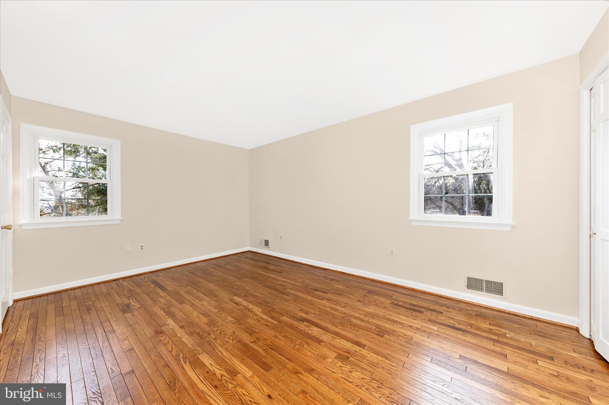 5815 Meadow Road Frederick, MD 21702 - Photo 32 of 55 an empty room with wooden floor and windows