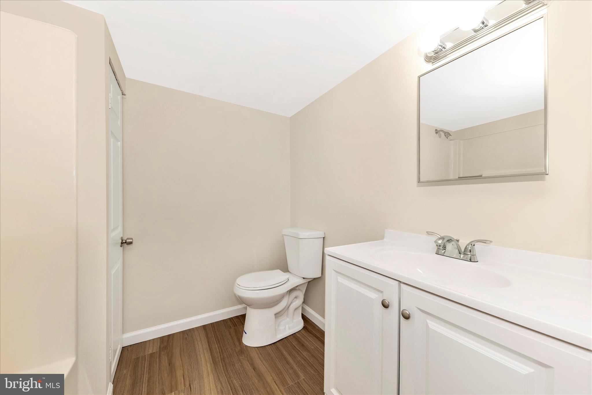 5815 Meadow Road Frederick, MD 21702 - Photo 40 of 55 a bathroom with a sink a toilet and mirror