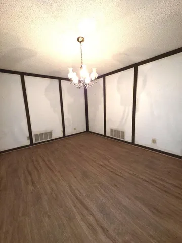 a view of a room with wooden floor and staircase