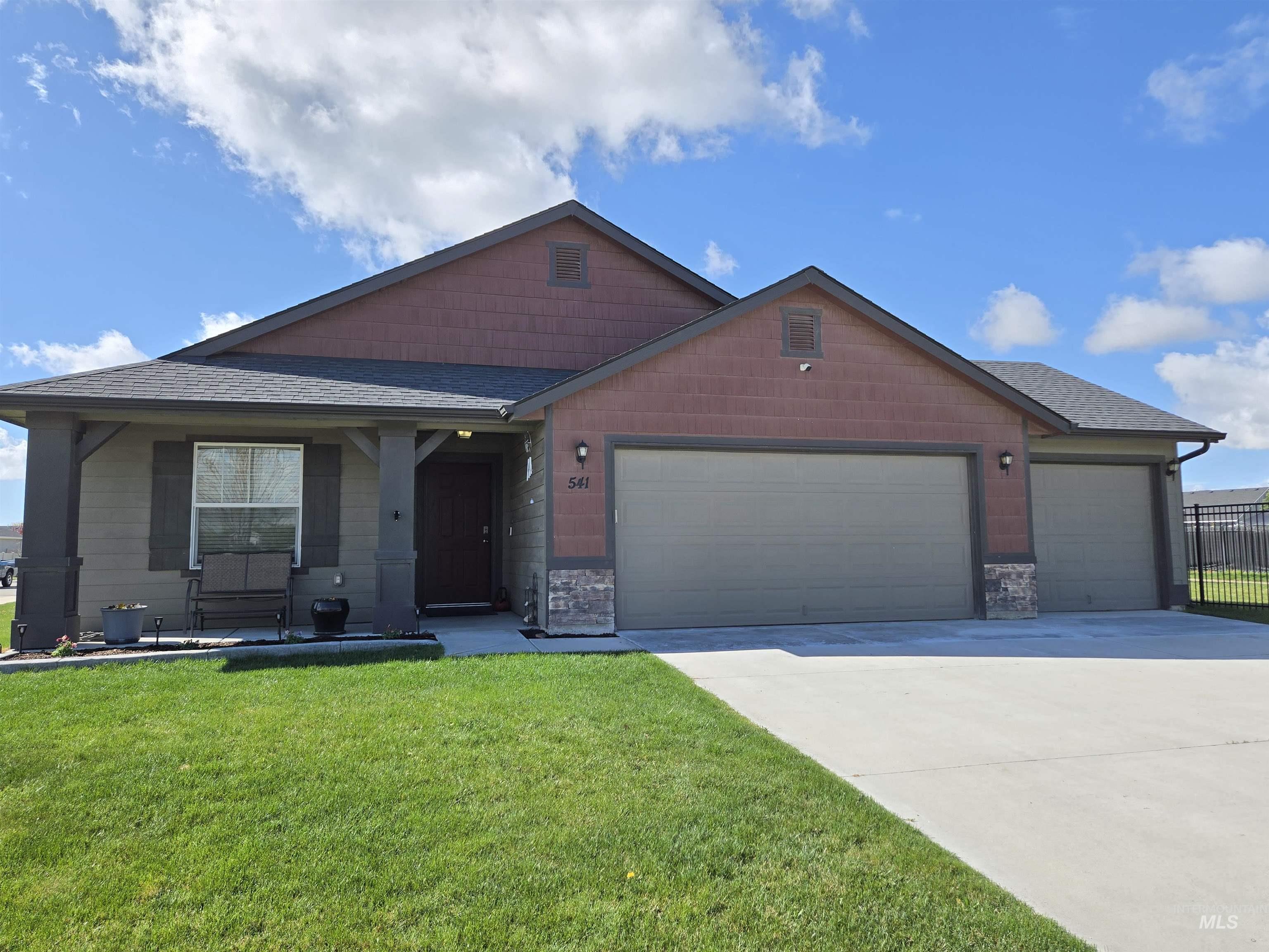 541 West Allspice Street Kuna, ID 83634 - Photo 1 of 1 View of front of property with a garage, a shingled roof, driveway, and a front yard