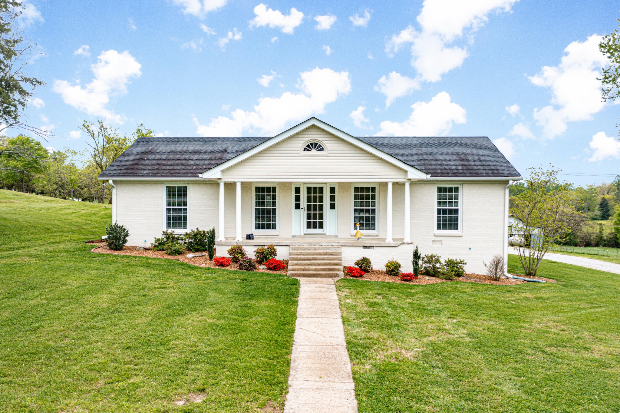 4861 Bethesda Road Thompson's Station, TN 37179 - Photo 2 of 22 a front view of a house with a garden