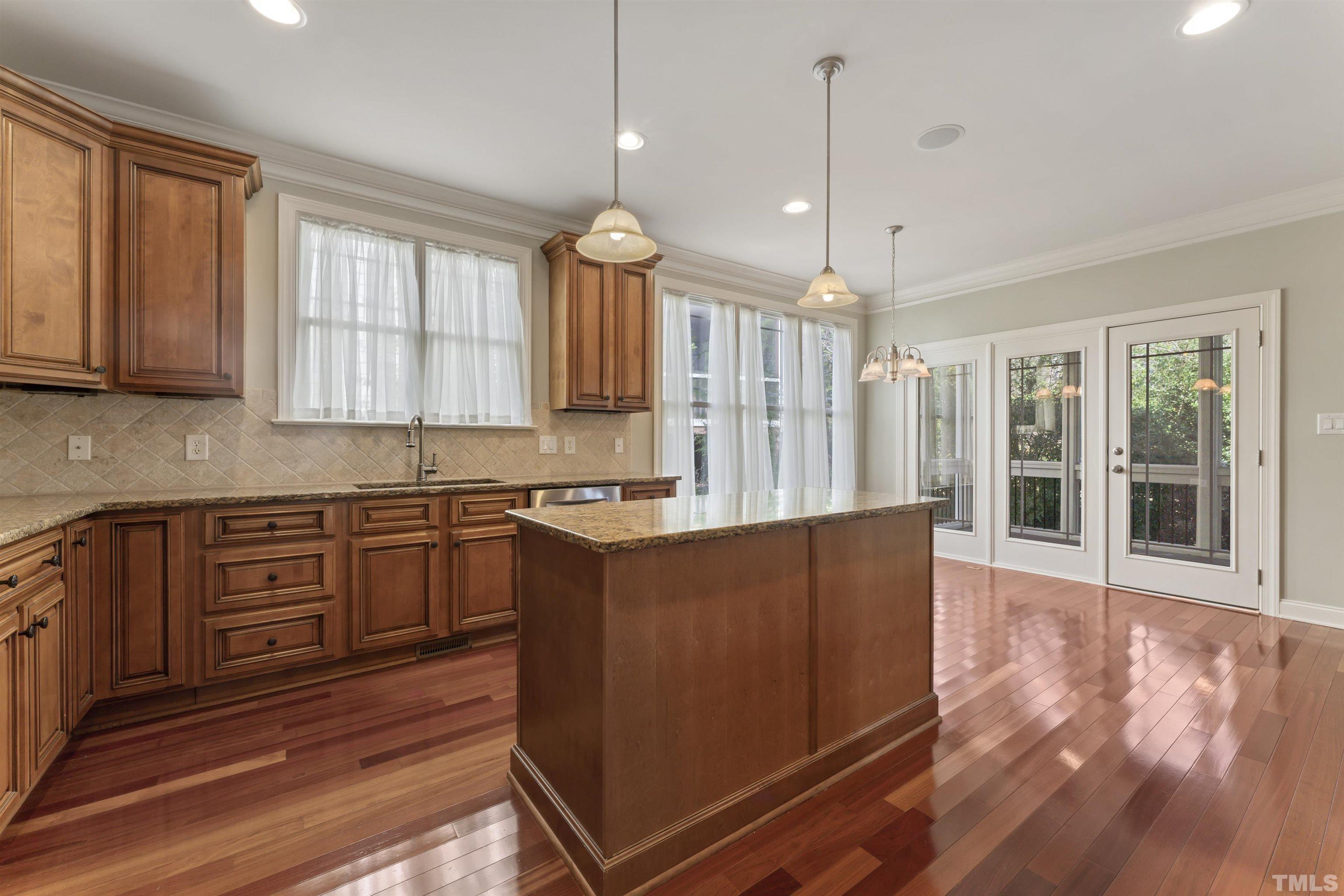 2809 Peachleaf Street Raleigh, NC 27614 - Photo 3 of 18 a kitchen with stainless steel appliances granite countertop a refrigerator a sink dishwasher a stove and white cabinets with wooden floor