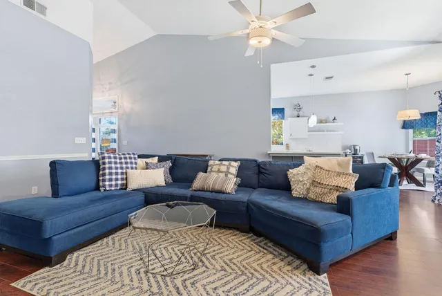 a living room with furniture ceiling fan and a rug