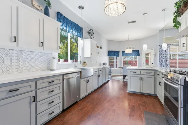 a kitchen with stainless steel appliances a stove a microwave and a refrigerator
