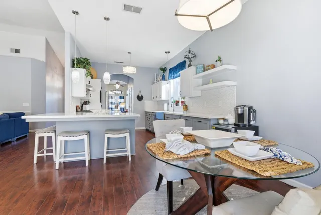 a view of a dining room with furniture and wooden floor