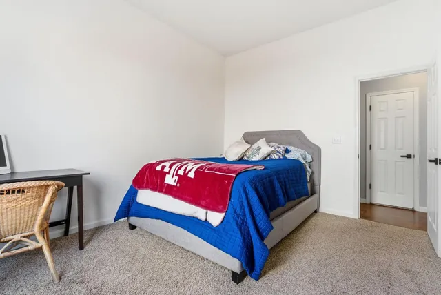 a bathroom with a granite countertop sink a toilet a mirror and shower