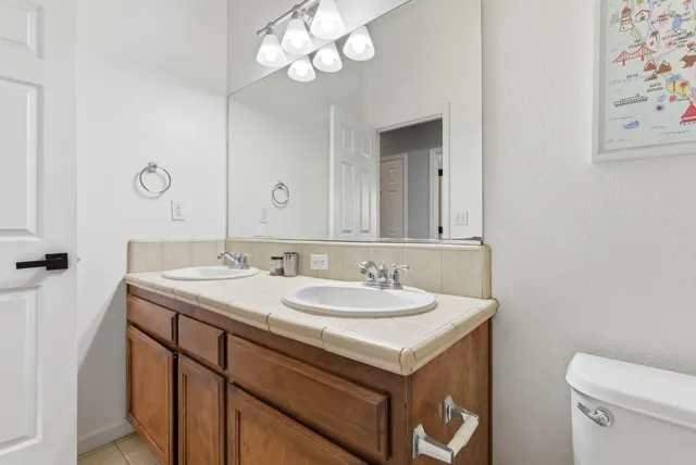 an empty room with a window and a ceiling fan