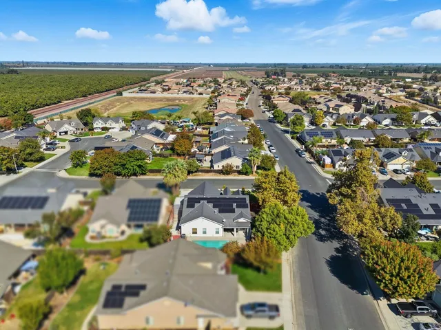 a front view of a house with a garden and plants