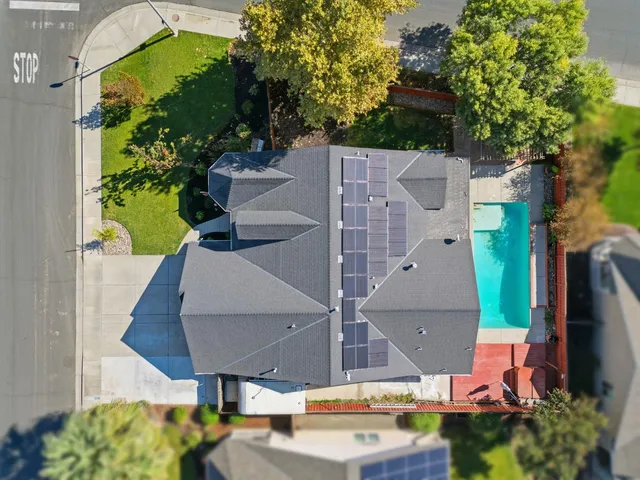 an aerial view of a house with garden space and street view