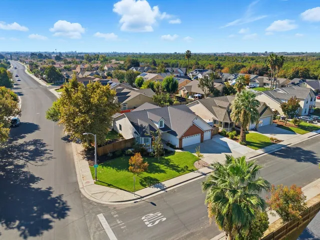 an aerial view of residential building and car parked on street side