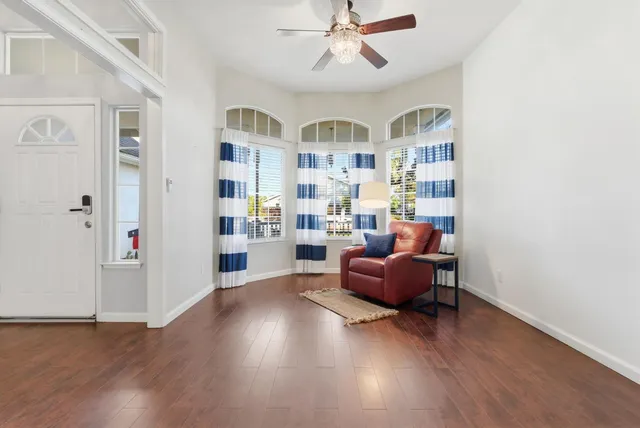a living room with furniture and a book shelf