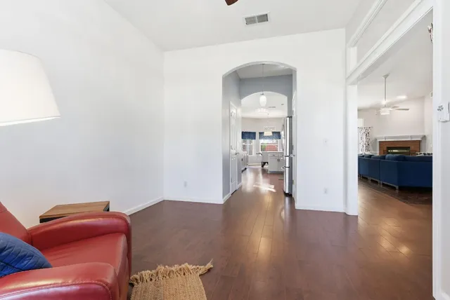 a living room with furniture and a wooden floor