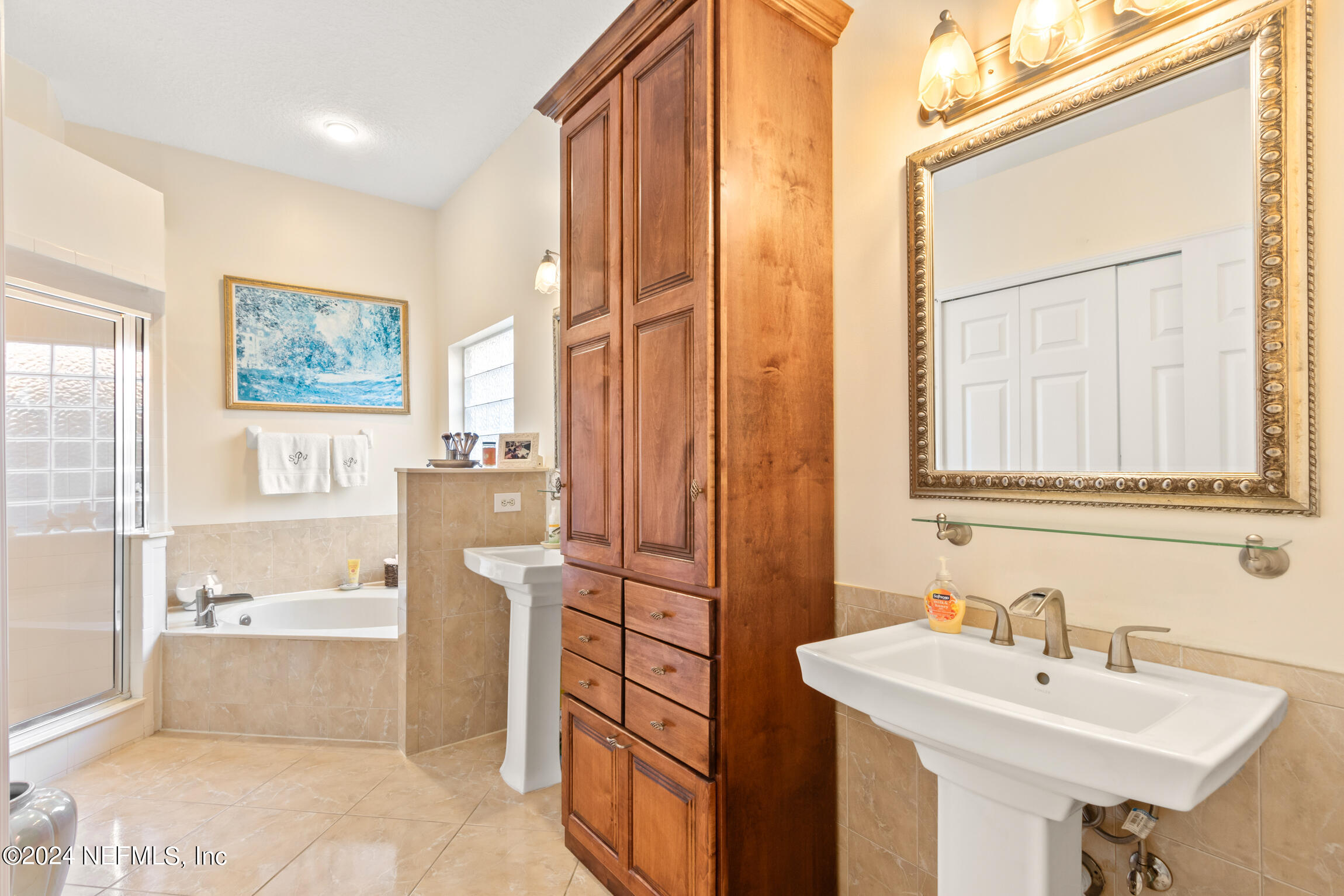 137 South Beach Drive St. Augustine, FL 32084 - Photo 13 of 41 a bathroom with a sink a bathtub and a mirror