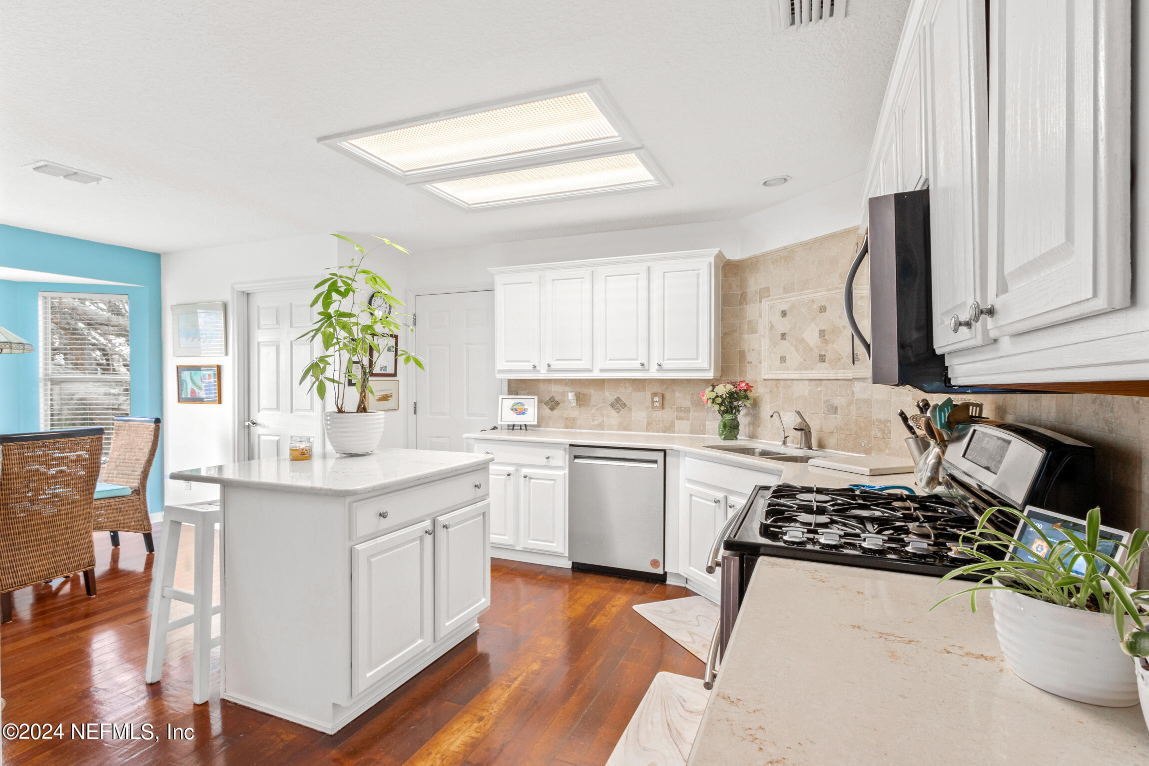 137 South Beach Drive St. Augustine, FL 32084 - Photo 15 of 41 a kitchen with a sink stove and white cabinets