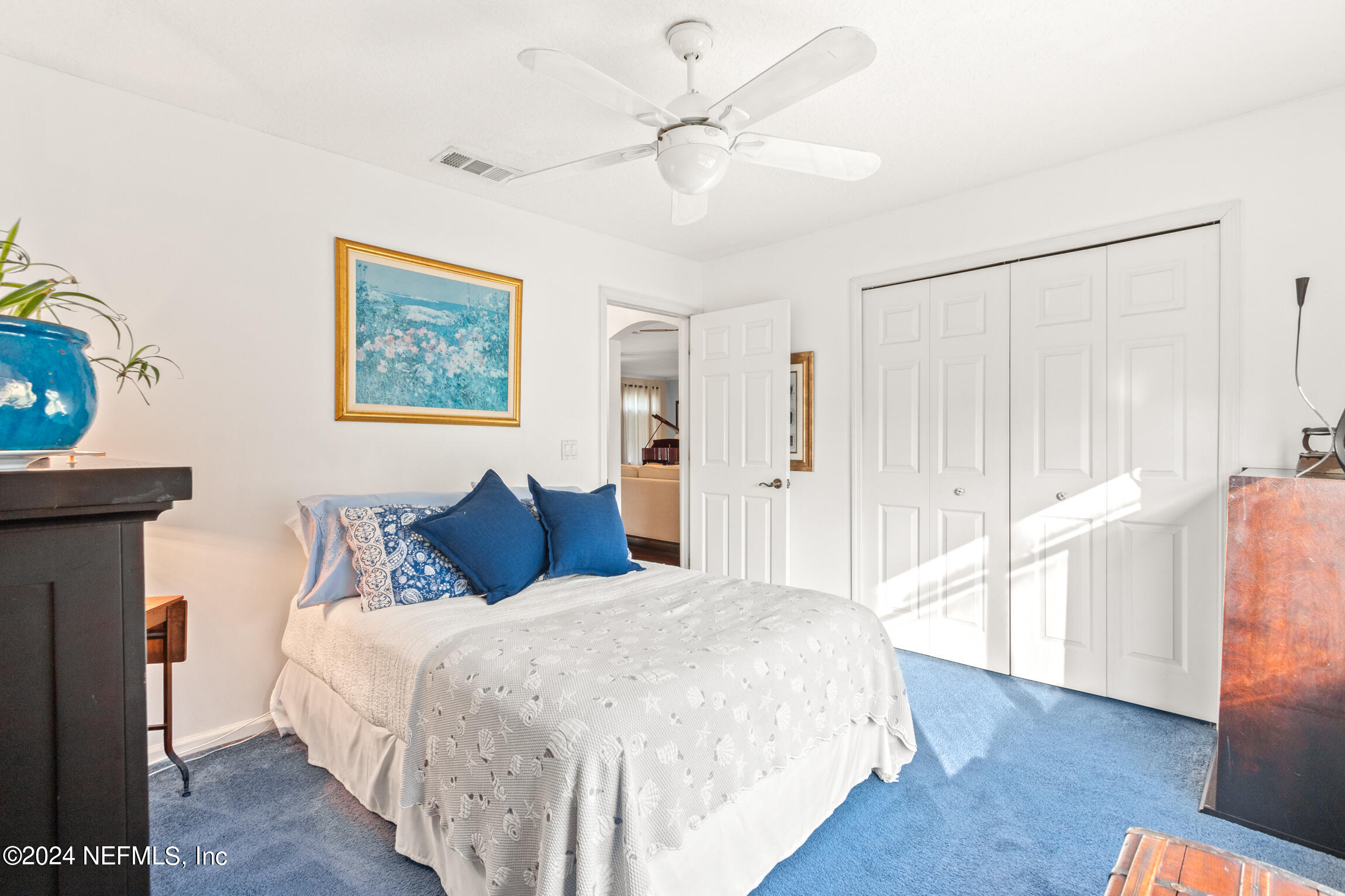 137 South Beach Drive St. Augustine, FL 32084 - Photo 21 of 41 a bedroom with a large bed and a chandelier