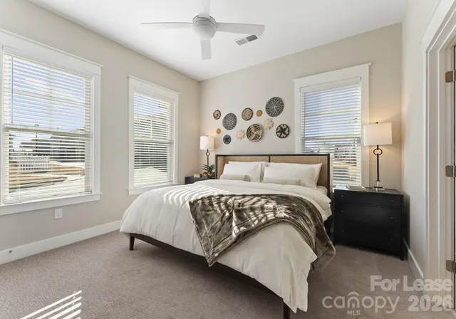 a bedroom with a large bed and a window