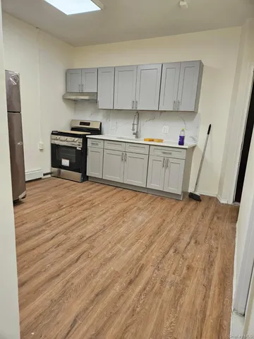 a kitchen with granite countertop a sink and a stove top oven