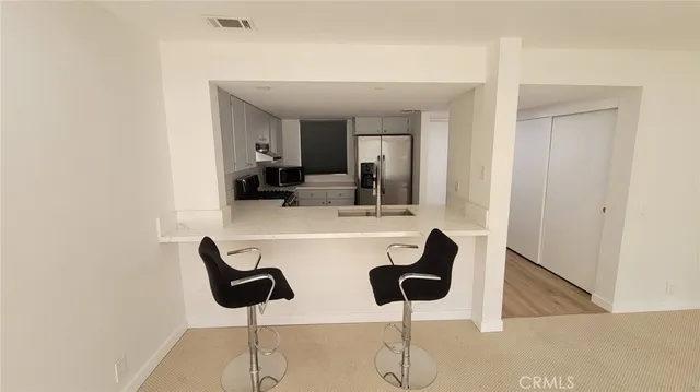 a kitchen with a refrigerator and a sink