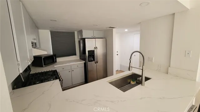 a spacious bathroom with double sink large mirror and a shower