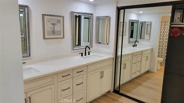 a bathroom with double vanity sink and mirror