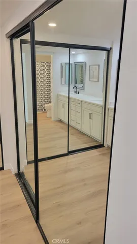 a spacious bathroom with white cabinets and a sink