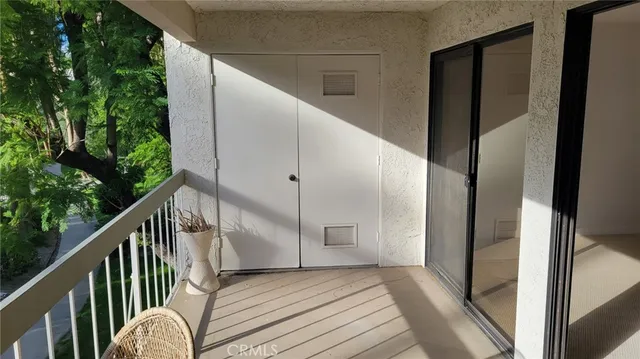 a kitchen with granite countertop white cabinets and stainless steel appliances