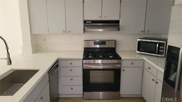 a view of dining room with wooden floor and chairs