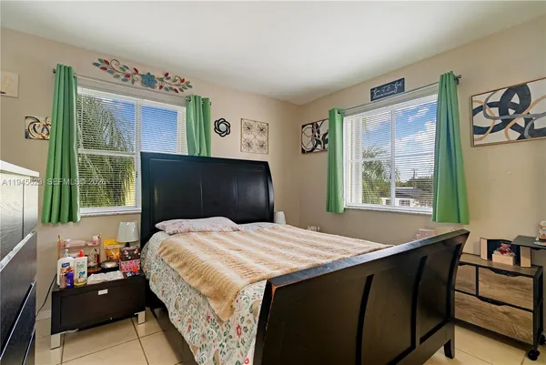 a bedroom with a large bed and a window