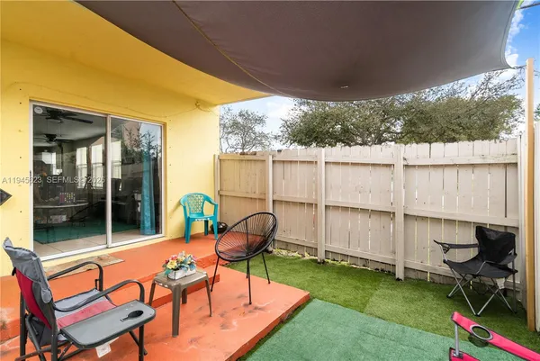 a balcony with table and chairs