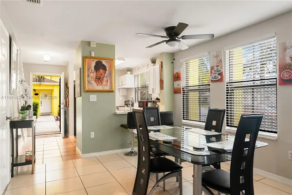 a view of a dining room with furniture and a chandelier