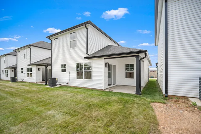 a view of a kitchen with wooden floor and a ceiling fan