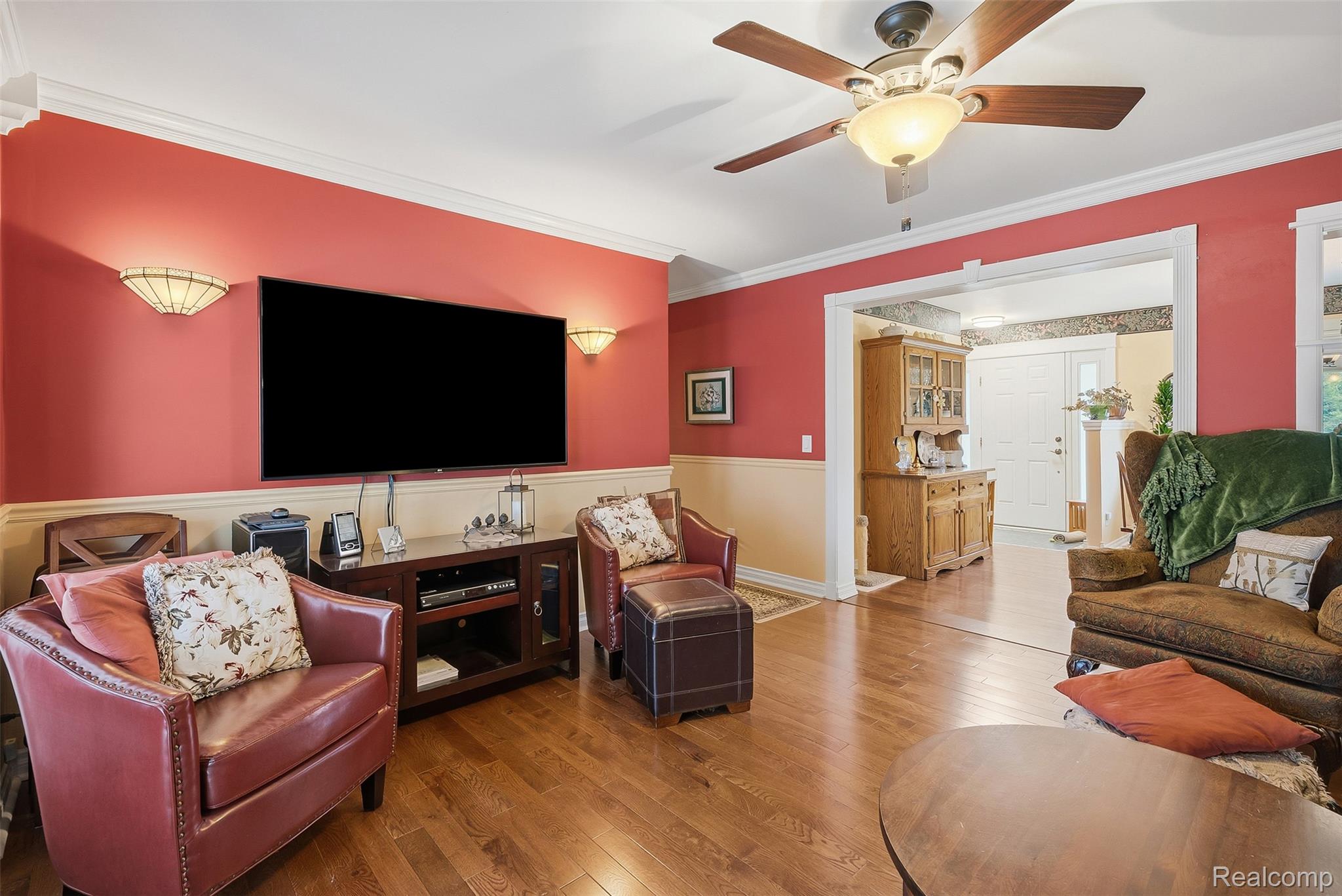 13182 Gilbert Road Memphis, MI 48041 - Photo 16 of 48 Spacious living area featuring wood-finish flooring, two-tone wall treatment with chair rail, and crown molding