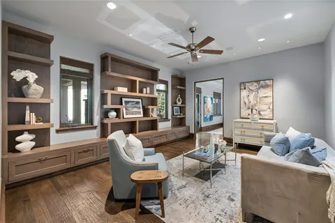 a living room with furniture and a wooden floor