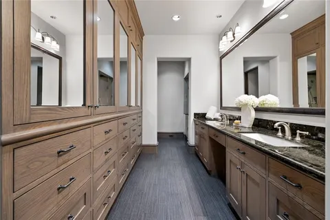 a large kitchen with stainless steel appliances granite countertop a large stove a sink dishwasher and cabinets with wooden floor