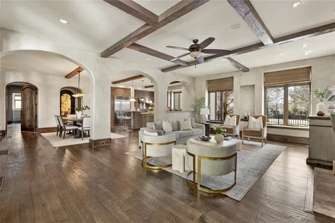 a living room with fireplace furniture and a large window