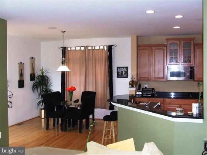 1307 Stallion Street Ranson, WV 25438 - Photo 3 of 22 a kitchen with granite countertop a sink cabinets and dining table