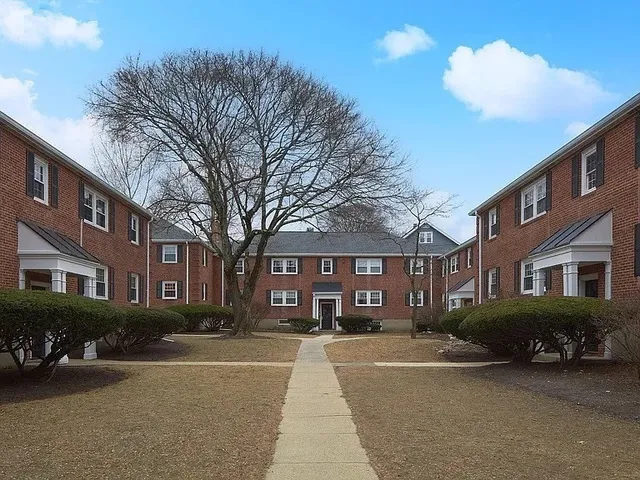 a view of a city street lined with buildings and trees