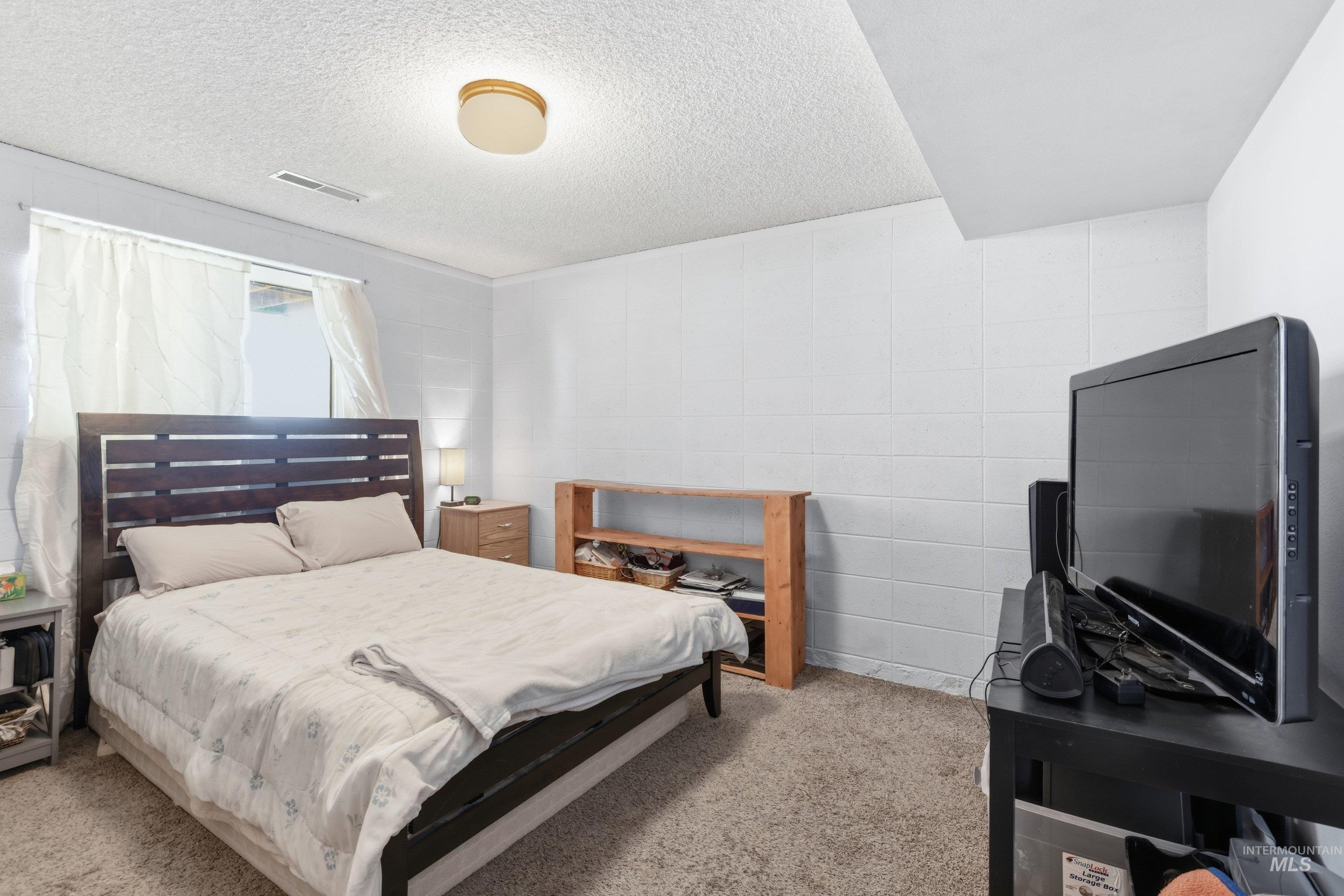 15095 David Street Caldwell, ID 83607 - Photo 17 of 39 Carpeted room with a window, white walls, and a textured ceiling