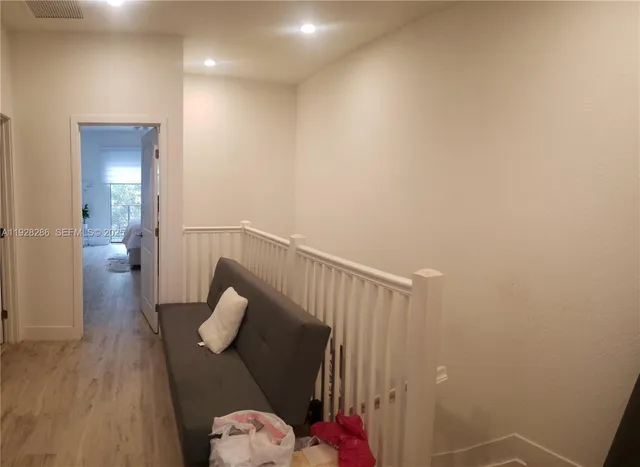 a bedroom with a bed potted plant with a large window