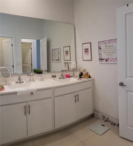 a bathroom with a double vanity sink and mirror
