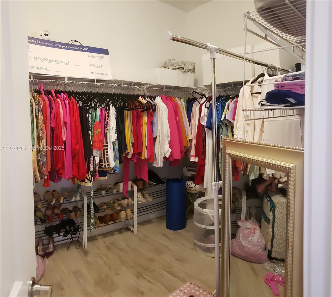 2414 Southwest 145th Place, Unit 2414 Miami, FL 33175 - Photo 19 of 29 a view of walk in closet with clothes and shoes